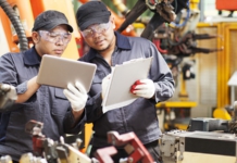 Effective Quality Management Through Smudgy Fingerprints manufacturing workers with tablets for quality management system